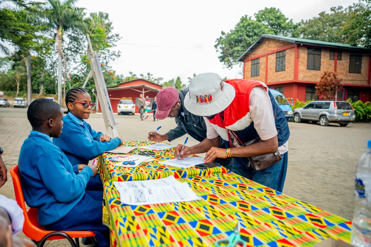 Students and a visitor taking part in an art activity at The School of St Jude